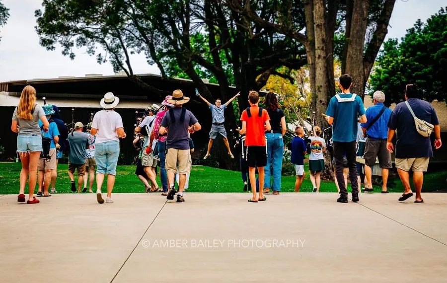 A crowd dancing on a lawn to the band’s music