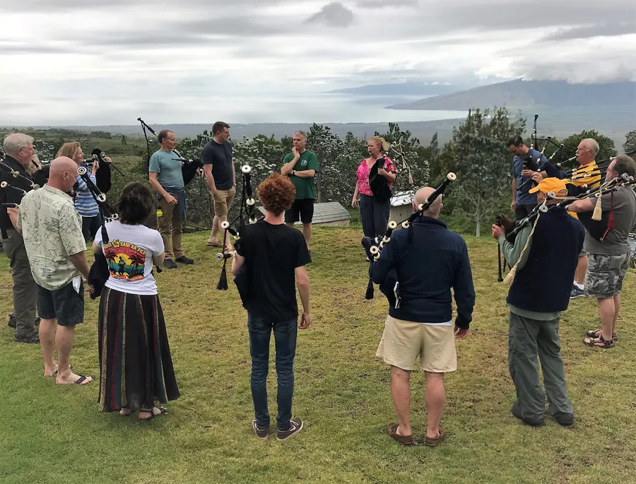 Pipers in a practice circle on a lawn
