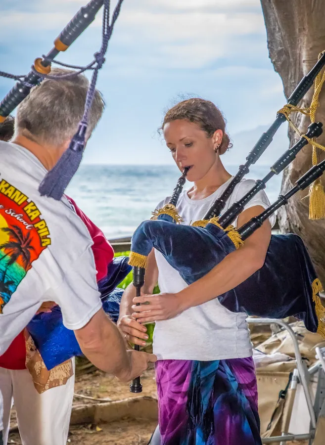 An instructor helping a young piper