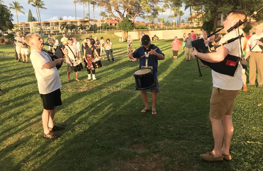 Pipers and drummers practicing on the lawn