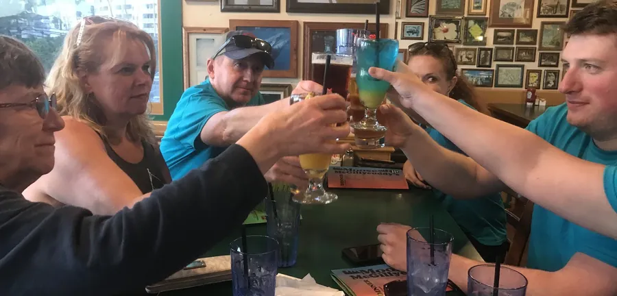 Glasses raised in a toast around the table